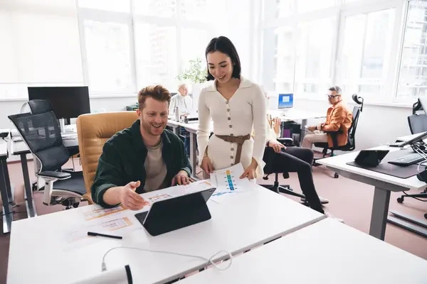 two employees working after workplace harassment training