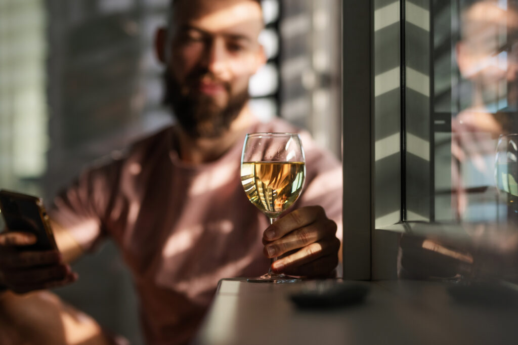man looking at wine glass needs alcohol drug abuse prevention training